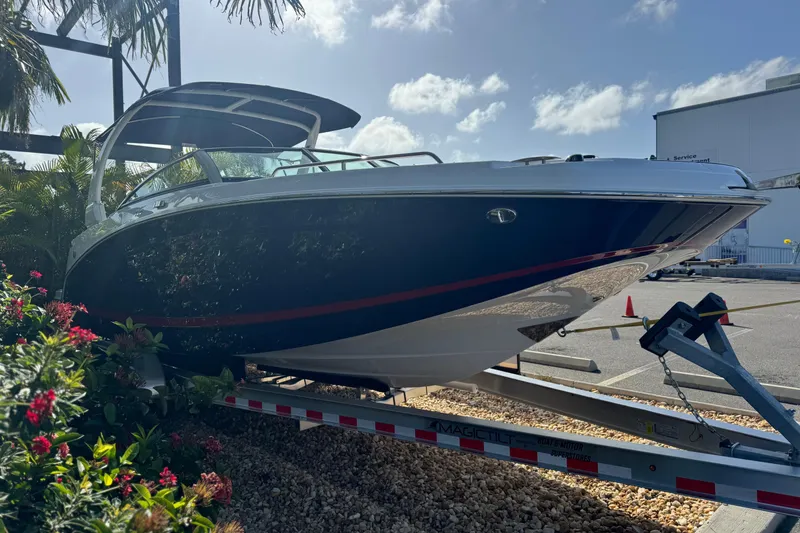 Slide: The Image of 2026 Four Winns HD8 OB boat on trailer, surrounded by tropical plants. - 13