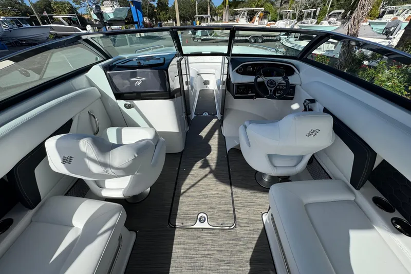 Slide: The Image of 2026 Four Winns HD8 OB boat interior with white seating and modern dashboard. - 23