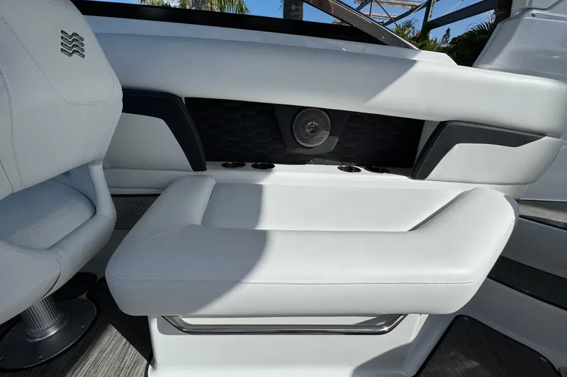 Slide: The Image of 2026 Four Winns HD8 OB boat interior with white seating and cup holders. - 24