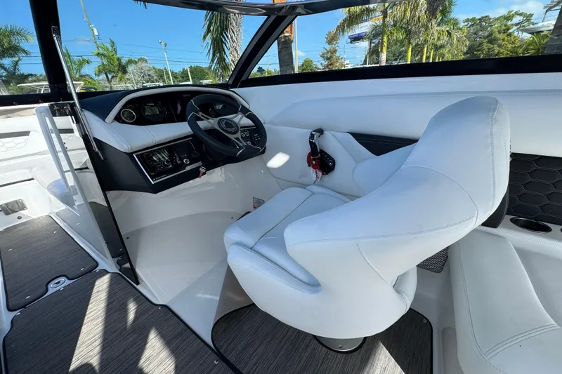 Slide: The Image of 2026 Four Winns HD8 OB boat interior with white captain's chair and modern dashboard. - 25