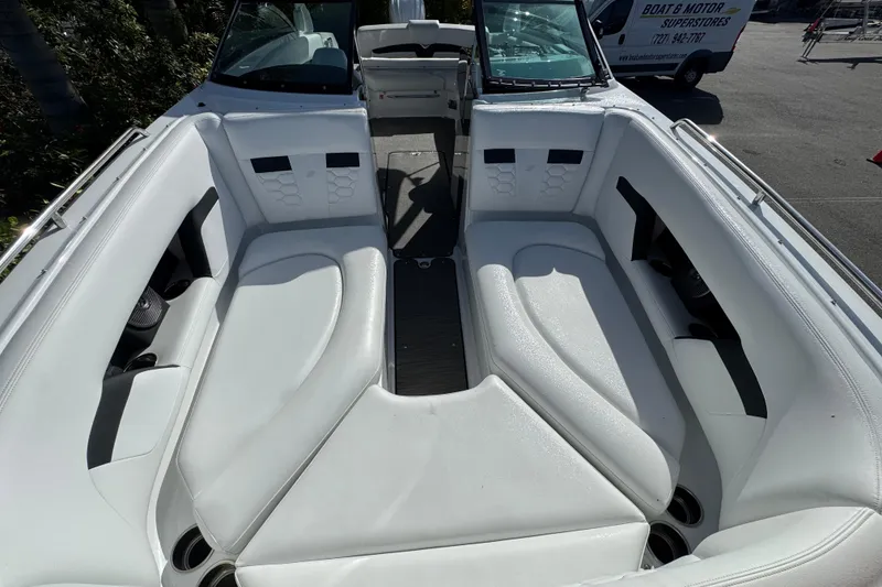 Slide: The Image of 2026 Four Winns HD8 OB boat interior with white seating and cup holders. - 31