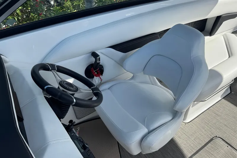 Slide: The Image of 2026 Four Winns HD8 OB boat cockpit with white captain's chair and steering wheel. - 35