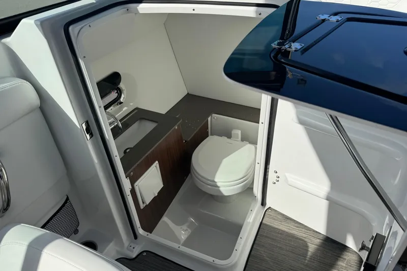 Slide: The Image of 2026 Four Winns HD8 OB boat interior with compact bathroom and modern amenities. - 38