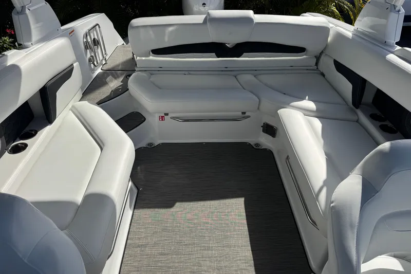Slide: The Image of 2026 Four Winns HD8 OB boat interior with white seating and gray flooring. - 40