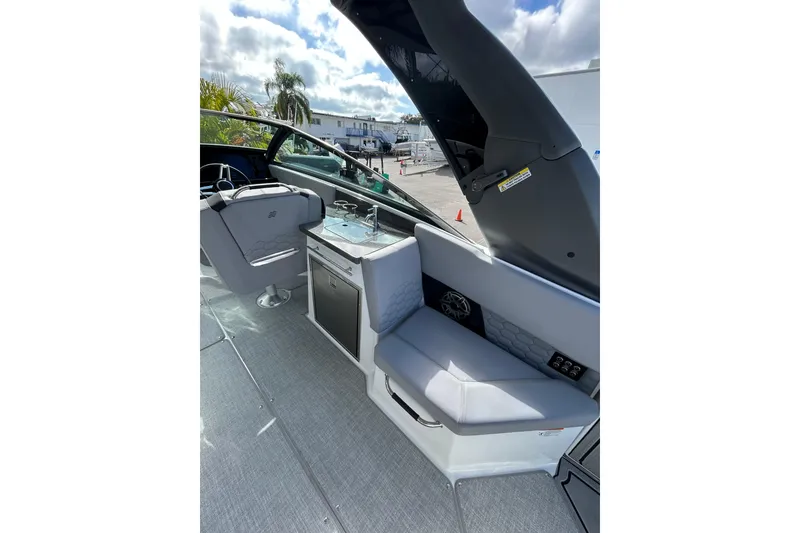 Slide: The Image of 2026 Four Winns H9 OB boat interior with seating and kitchenette. - 5