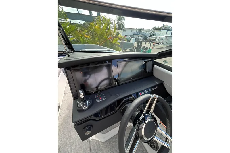 Slide: The Image of 2026 Four Winns H9 OB boat dashboard with modern controls and dual screens. - 7