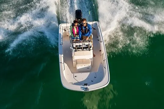 Slide: The Image of 2026 Boston Whaler 150 Montauk with Mercury outboard motor at marina. - 2