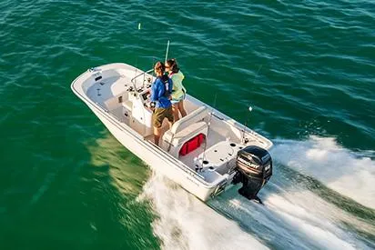 Slide: The Image of 2026 Boston Whaler 150 Montauk boat stern with outboard motor, docked on concrete. - 4