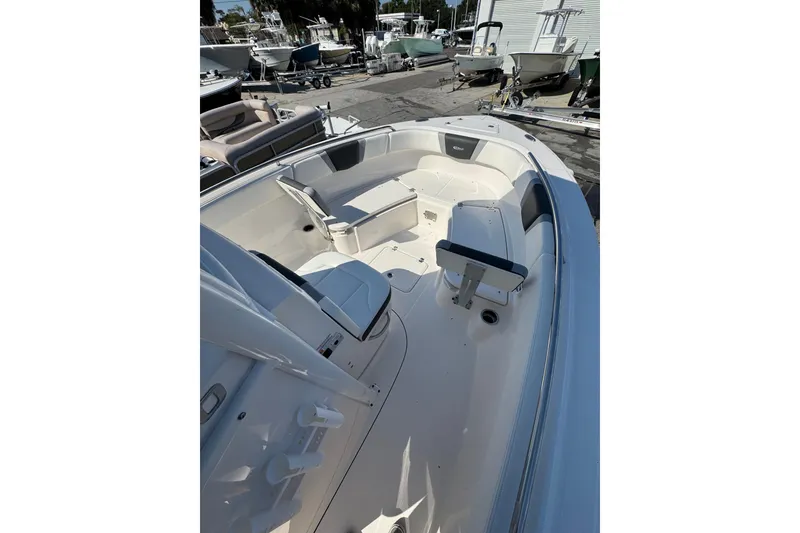 Slide: The Image of 2024 Robalo R230 Center Console boat interior with seating and storage. - 2