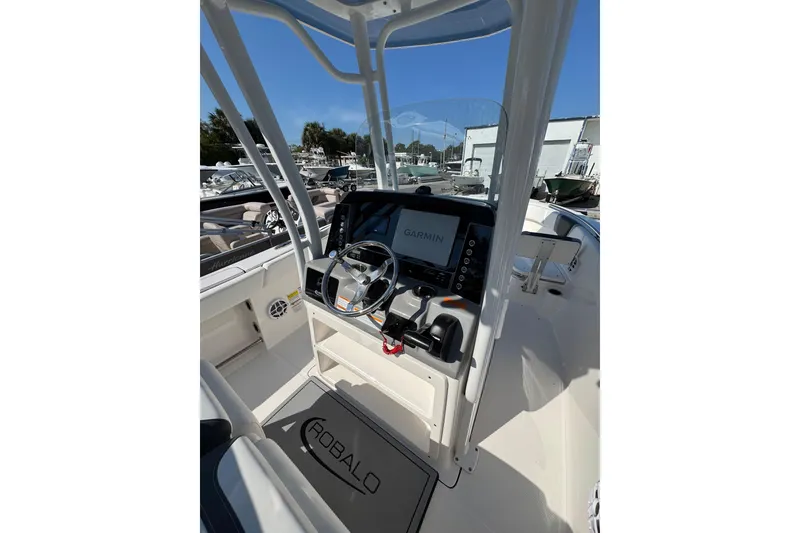 Slide: The Image of 2024 Robalo R230 Center Console boat interior with Garmin navigation system and steering wheel. - 5