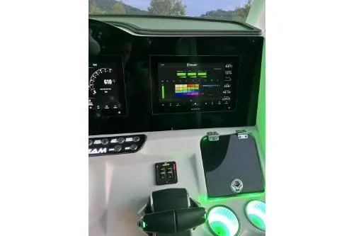 Slide: The Image of 2023 Glasstream 328 SCX dashboard with digital displays and illuminated controls. - 11