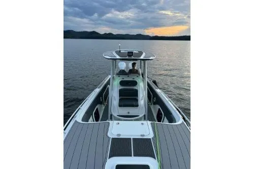 Slide: The Image of 2023 Glasstream 328 SCX boat on calm water at sunset. - 12