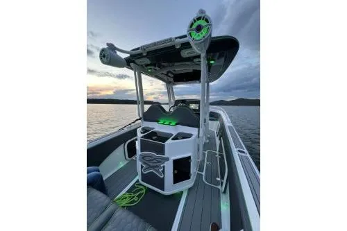 Slide: The Image of 2023 Glasstream 328 SCX boat with illuminated console and speakers on a serene lake. - 13
