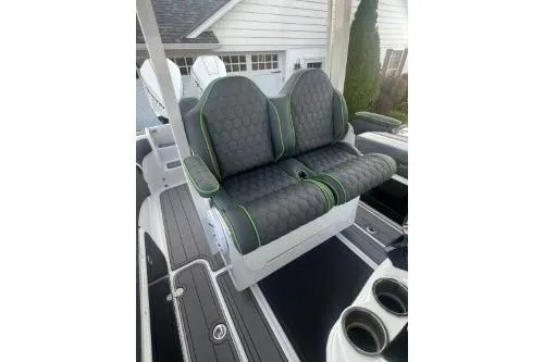 Slide: The Image of 2023 Glasstream 328 SCX boat seats with hexagonal pattern and green accents. - 18