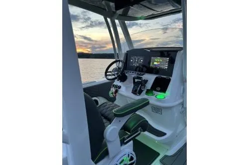 Slide: The Image of 2023 Glasstream 328 SCX boat cockpit with modern controls at sunset. - 22