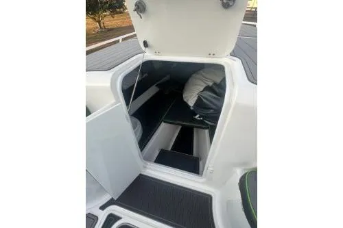 Slide: The Image of 2023 Glasstream 328 SCX boat storage compartment with open hatch and visible interior. - 24