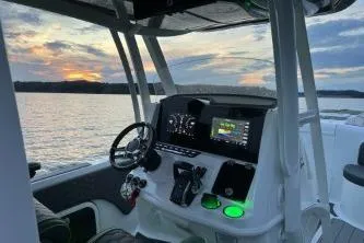 Slide: The Image of 2023 Glasstream 328 SCX boat interior with sunset view over water. - 25