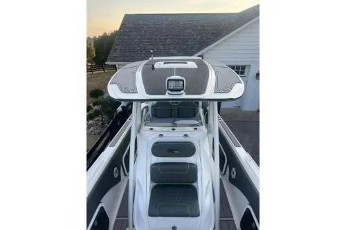 Slide: The Image of 2023 Glasstream 328 SCX boat with sleek design and modern features, docked near a house. - 28