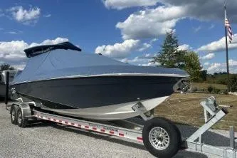 Slide: The Image of 2023 Glasstream 328 SCX boat on trailer, covered, under a partly cloudy sky. - 3