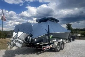 Slide: The Image of 2023 Glasstream 328 SCX boat on trailer, covered, with American flag in background. - 4