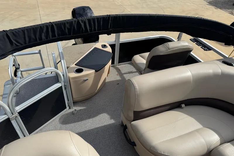 Slide: The Image of 2019 Sun Tracker Bass Buggy 18 DLX pontoon boat interior with beige seating and console. - 3