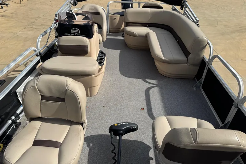 Slide: The Image of 2019 Sun Tracker Bass Buggy 18 DLX pontoon boat interior with beige seating. - 5