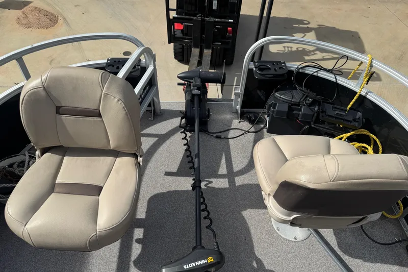 Slide: The Image of 2019 Sun Tracker Bass Buggy 18 DLX interior with two seats and fishing equipment. - 6