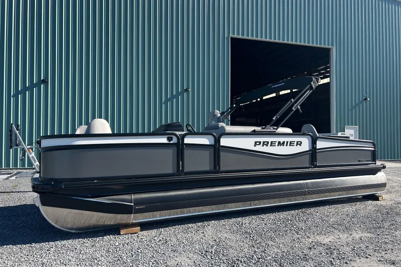 The Image of 2026 Premier 230 Sunsation Angler 4pt pontoon boat outside a large warehouse. - 0