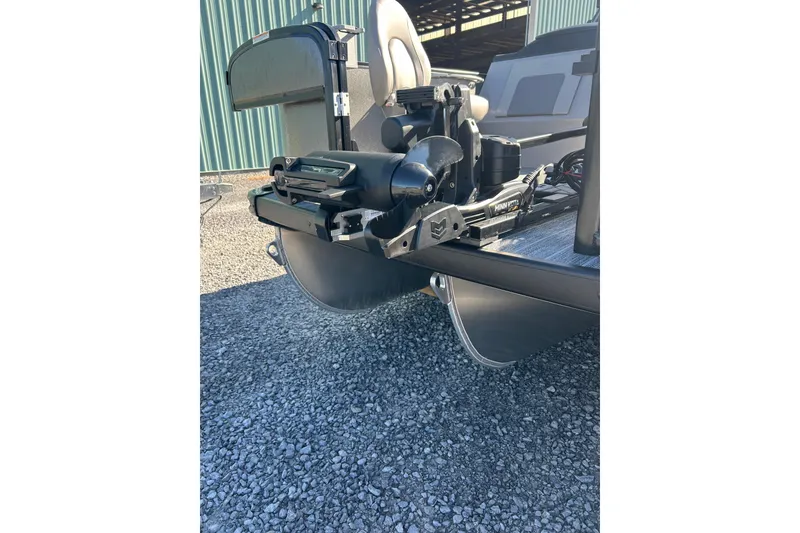Slide: The Image of 2026 Premier 230 Sunsation Angler 4pt boat with Minn Kota motor, on gravel surface. - 14