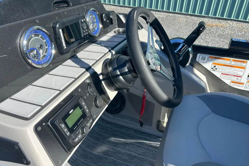 Slide: The Image of 2026 Premier 230 Sunsation Angler 4pt boat dashboard with steering wheel and controls. - 22