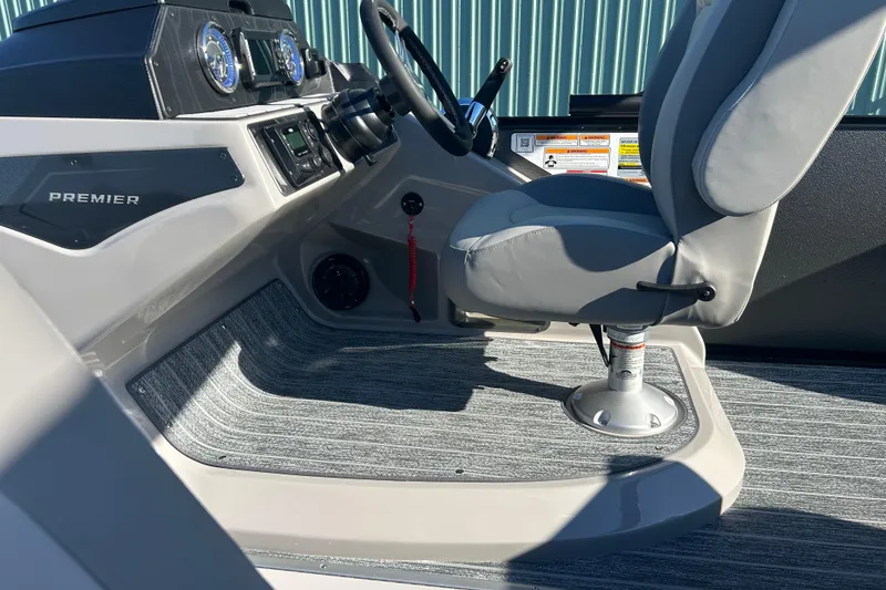 Slide: The Image of Interior of 2026 Premier 230 Sunsation Angler 4pt boat with steering console and seat. - 23