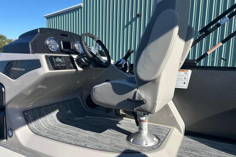 Slide: The Image of Premier 230 Sunsation Angler 4pt 2026 boat interior with steering console and seat. - 24