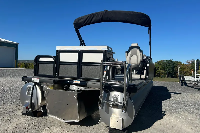 Slide: The Image of 2026 Premier 230 Sunsation Angler 4pt pontoon boat with canopy, parked outdoors. - 6