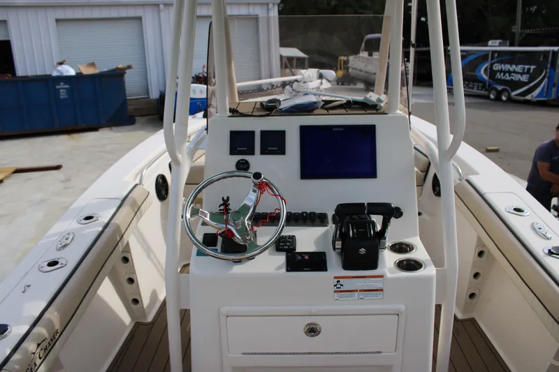Slide: The Image of 2022 Sea Chaser 24 HFC boat console with steering wheel and navigation controls. - 12