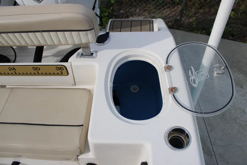 Slide: The Image of 2022 Sea Chaser 24 HFC boat interior with open storage compartment and seating. - 13