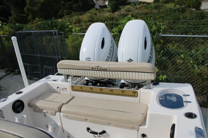 Slide: The Image of 2022 Sea Chaser 24 HFC boat with dual Suzuki outboard motors and seating area. - 15