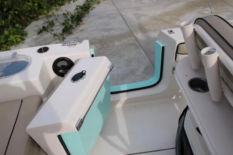 Slide: The Image of 2022 Sea Chaser 24 HFC boat interior with storage compartments and rod holders. - 4