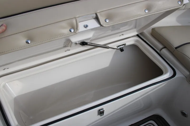 Slide: The Image of Open storage compartment on 2022 Sea Chaser 24 HFC boat, featuring cushioned seating. - 7