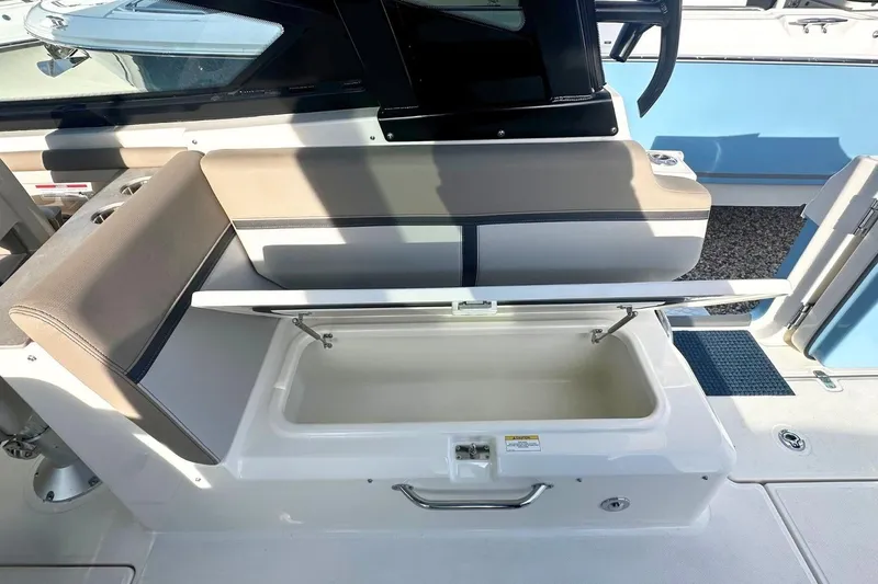 Slide: The Image of 2026 Boston Whaler 330 Vantage boat seat with storage compartment open. - 16