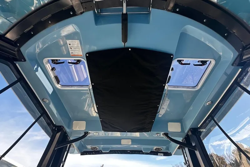 Slide: The Image of 2026 Boston Whaler 330 Vantage boat interior roof with skylights and blue finish. - 20