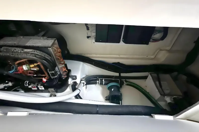 Slide: The Image of Engine compartment of 2026 Boston Whaler 330 Vantage, showcasing mechanical components and wiring. - 25