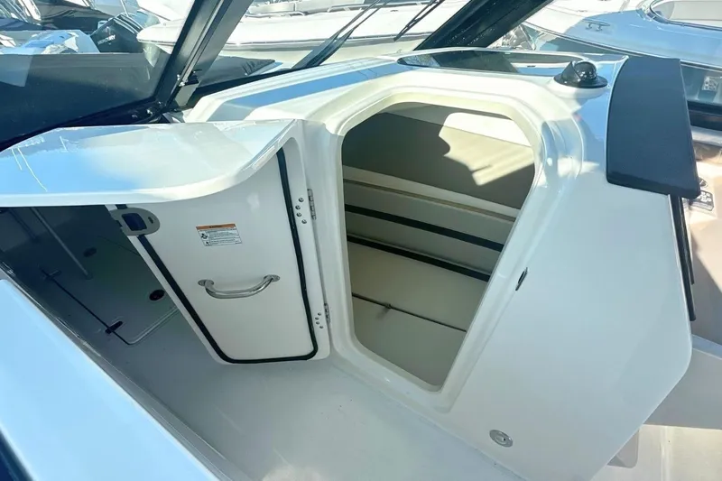 Slide: The Image of 2026 Boston Whaler 330 Vantage cabin interior with open door, showcasing sleek design. - 26