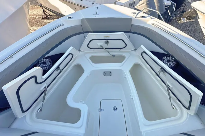 Slide: The Image of 2026 Boston Whaler 330 Vantage boat with open storage compartments and sleek design. - 33