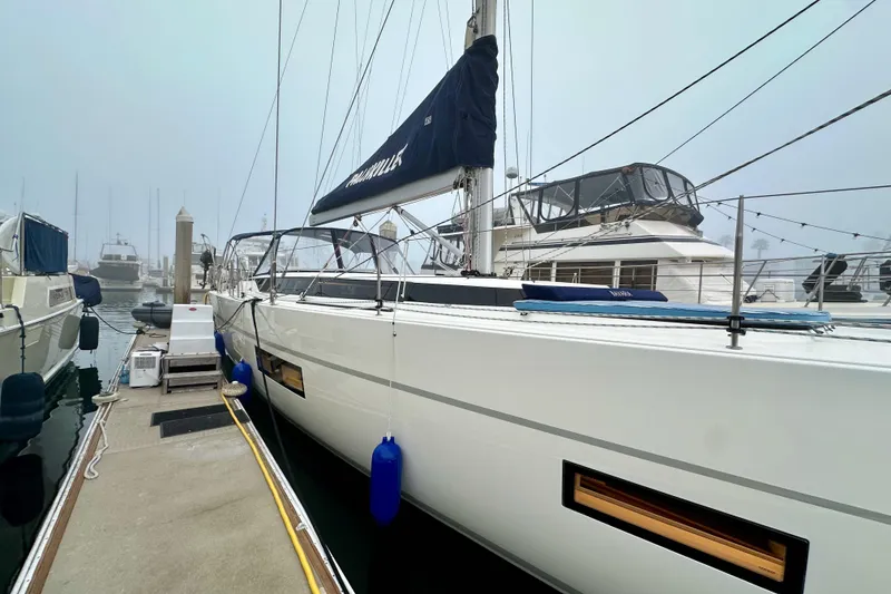 Slide: The Image of 2020 Bavaria C50 yacht docked in a foggy marina, showcasing sleek design and modern features. - 12