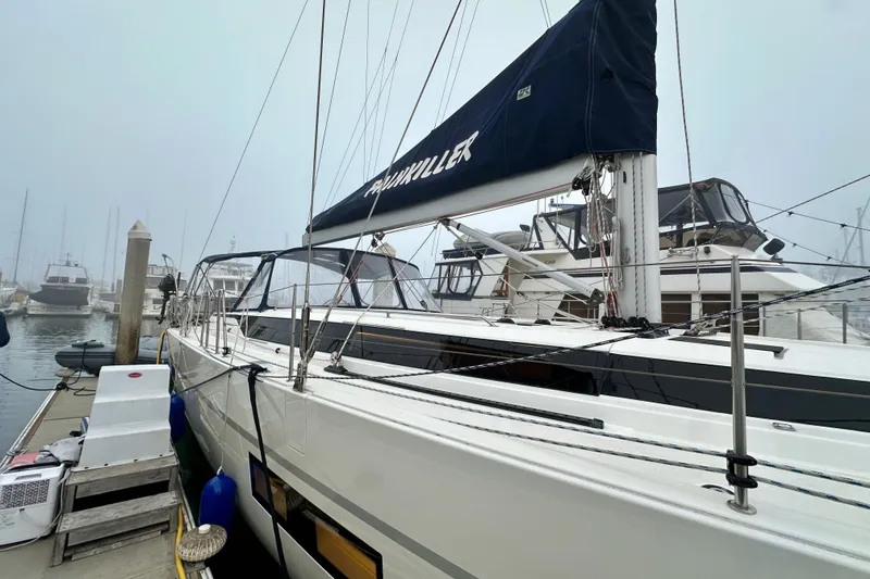 Slide: The Image of 2020 Bavaria C50 sailboat docked in a foggy marina, showcasing sleek design and modern features. - 13