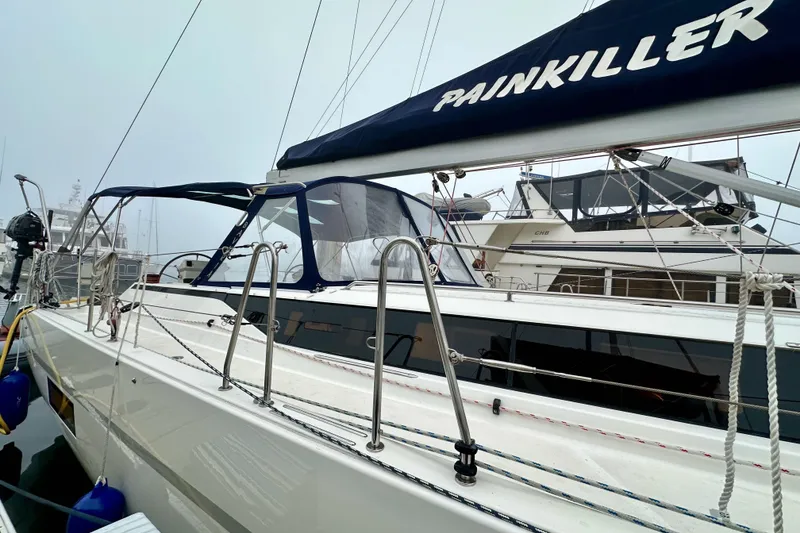 Slide: The Image of 2020 Bavaria C50 sailboat "Painkiller" docked, featuring sleek design and modern rigging. - 14