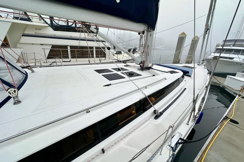Slide: The Image of 2020 Bavaria C50 yacht docked in a foggy marina, showcasing sleek design and modern features. - 18