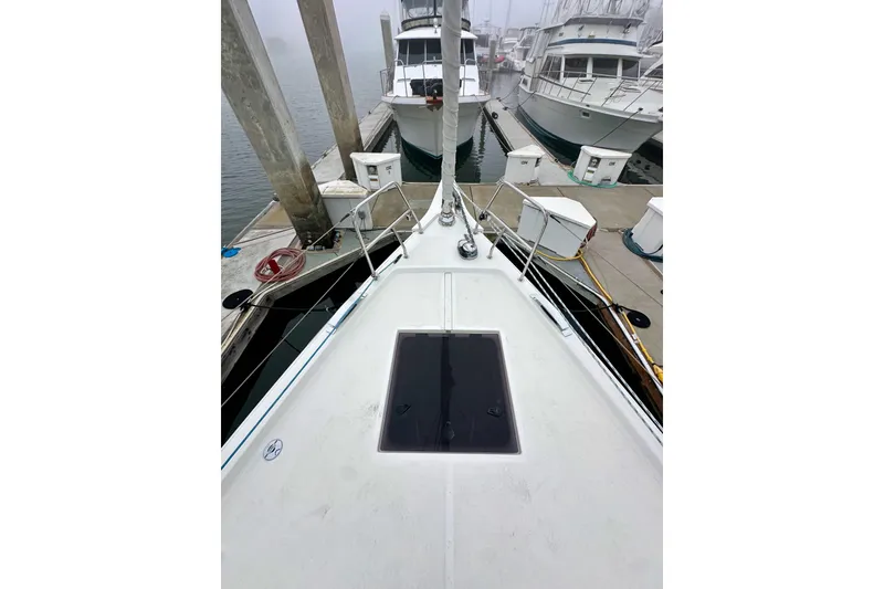 Slide: The Image of 2020 Bavaria C50 yacht docked at marina, foggy background, view from bow. - 20