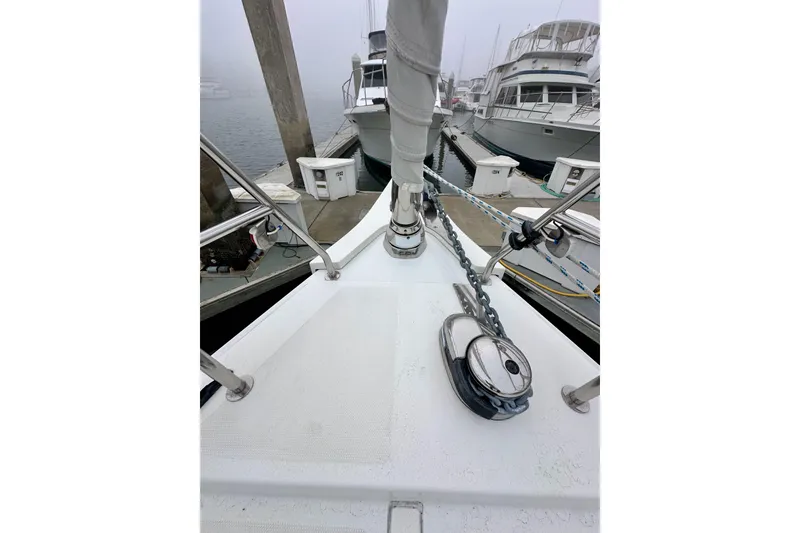 Slide: The Image of Bow of 2020 Bavaria C50 yacht docked at marina, featuring anchor chain and winch. - 22