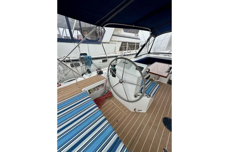 Slide: The Image of 2020 Bavaria C50 yacht cockpit with striped seating and steering wheel. - 31